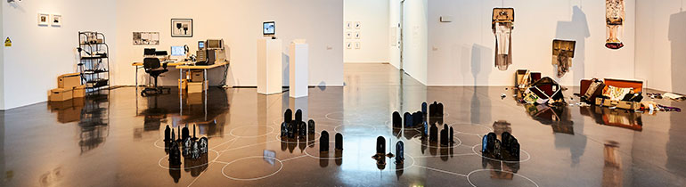 Photograph of various artworks, including sculptures paintings, photographs and installations, on display at the New Gallery Walsall during the MA Fine Art exhibition