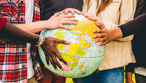 group of students holding a globe