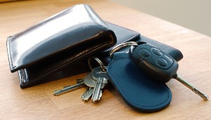 A set of keys and a wallet left on a tabletop