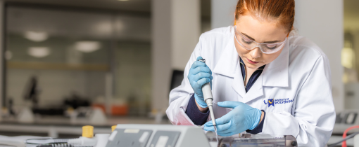 Student in lab coat in a science laboratory