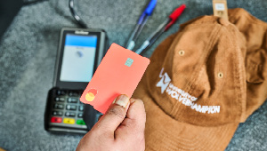 student attempting to pay for items in a shop by debit card